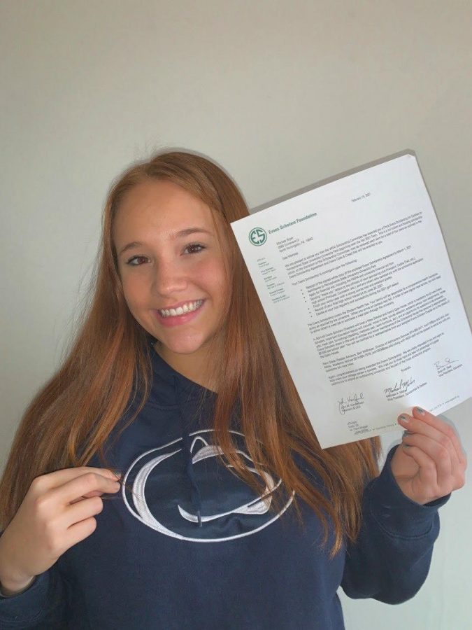 Marissa+Boyer+with%C2%A0+Chick+Evans+Scholarship+letter+and+Penn+State+University+merch.