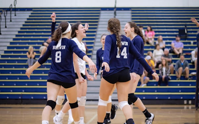 Norwin girls volleyball players celebrate after a point in the 2019 season.  