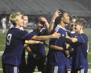 The Boys Soccer team rallies around senior Caleb Yuricha after he scores against Allderdice on Oct. 7.