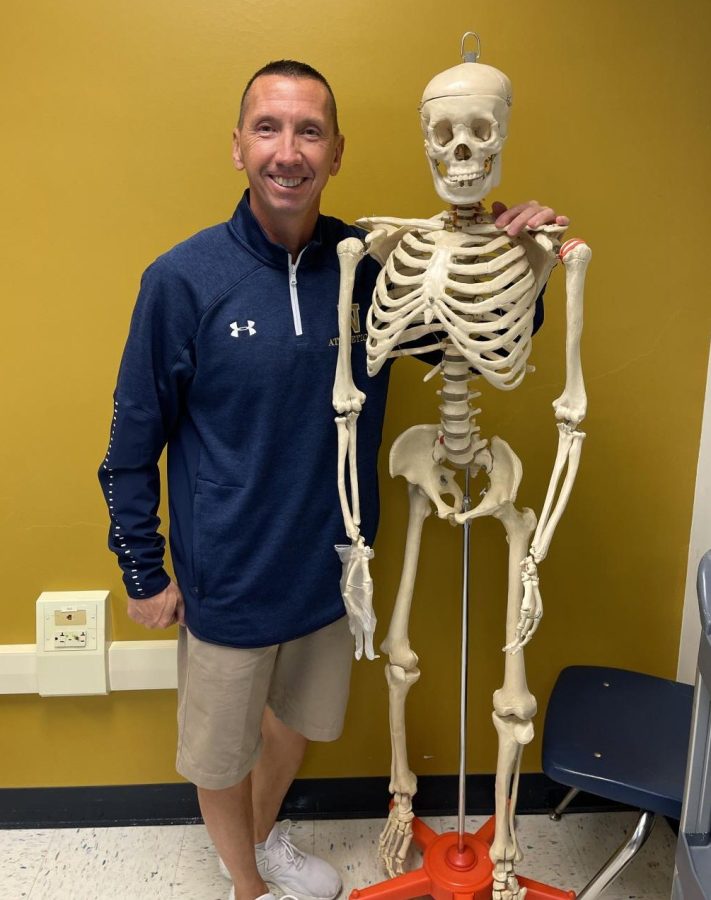 Mr. Mesich poses with the skeleton he uses to teach his Anatomy students. 