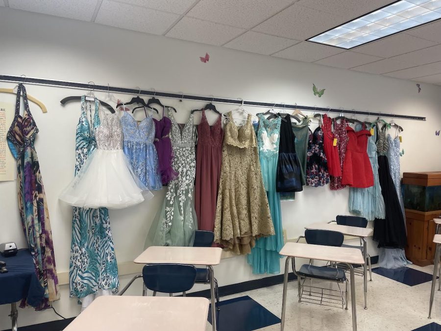 Donated and consigned dresses line the wall waiting to be sold at the upcoming sale.