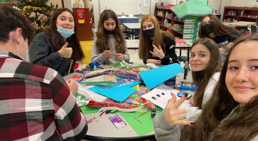 FCCLA club members finish decorating cards and packing the desserts for the community.