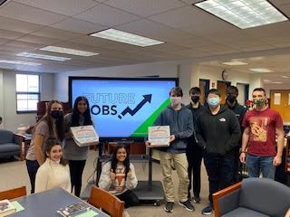 Students posing for a picture during the competition in the Library. 