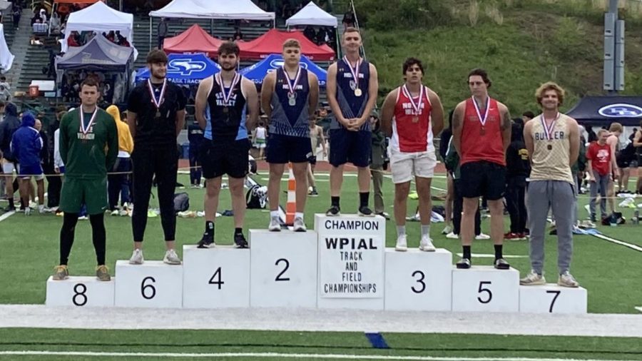 Scherle and Schmook stand on the podium at the WPIAL Track and Field Individual Finals.