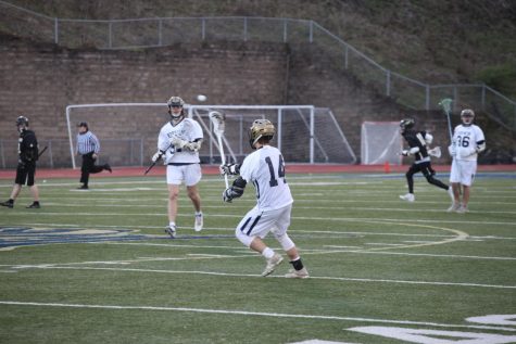 Senior Jon Colombus receives the pass from Ryan Frankovic as the team heads down field.
