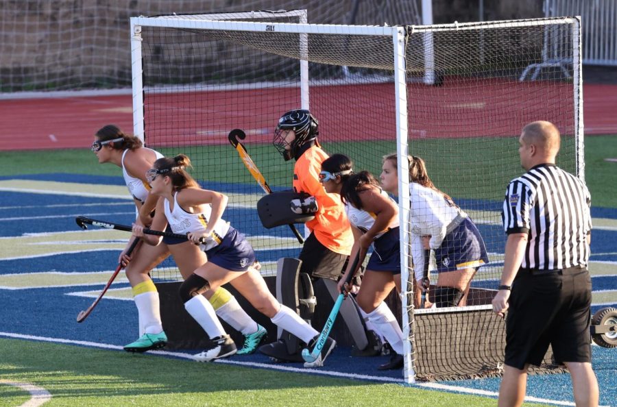 The junior varsity defensive line bursts out of the goal during a corner. From left to right: Anika Painter (10), Maddy Bulger (9), Ray Mamas (11), Harneet Singh (11), and Savannah Scholl (11). 