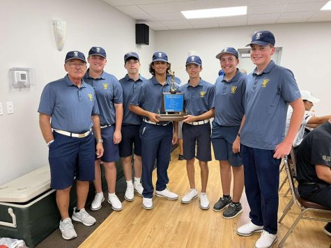 The boys golf team and Coach Rushnock pose with the Westmoreland County Coaches Championship trophy which the boys captured this September for the first time in 10 years.