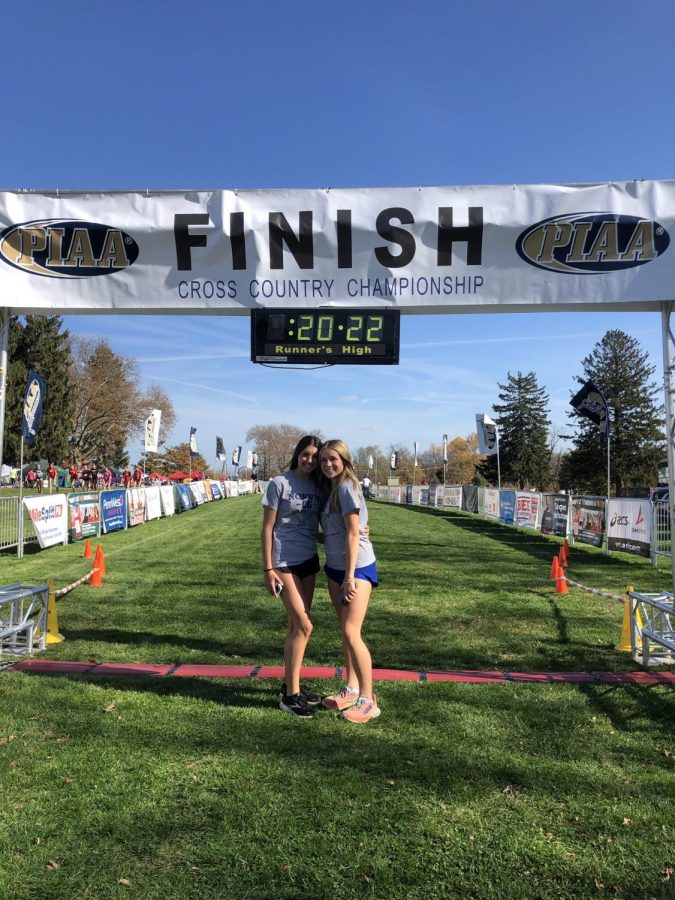 Freshman Annie Czajkowski and junior Rosemary Gaydos pose under the finish line at the PIAA XC Championship course in Hershey, PA. Cjazkowski finished 57th in the AAA girls race.