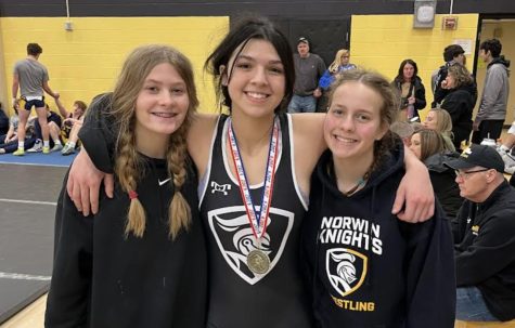 Freshmen Victoria Marflak, Josephine Dollman, and Anna Wendt pose for a picture after a long day of wrestling. 