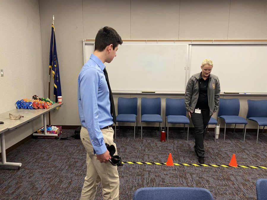 Nicholas Cormas (12) takes a simulation field sobriety test after learning about the dangers of driving under the influence. 