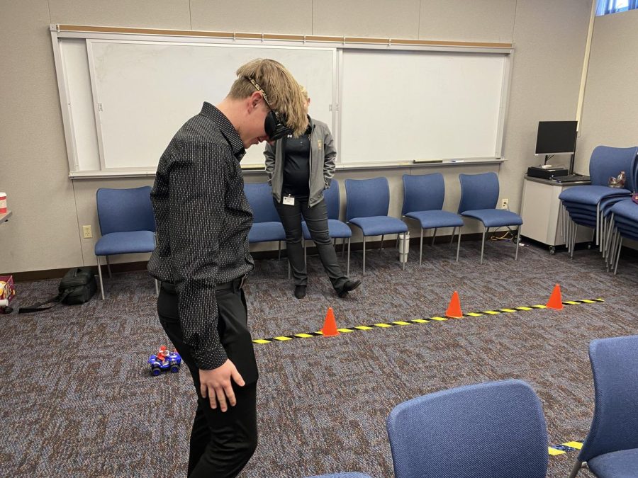 Caden Hoffman (12) tries to pass a simulation field sobriety test with intoxication simulating goggles on. 
