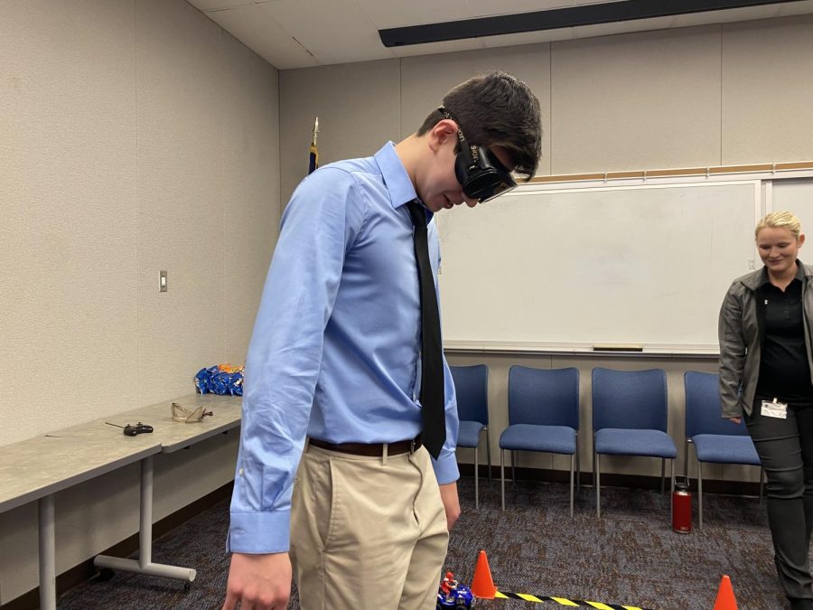 Nicholas Cormas (12) tries to walk in a straight line with intoxication simulating goggles on. 