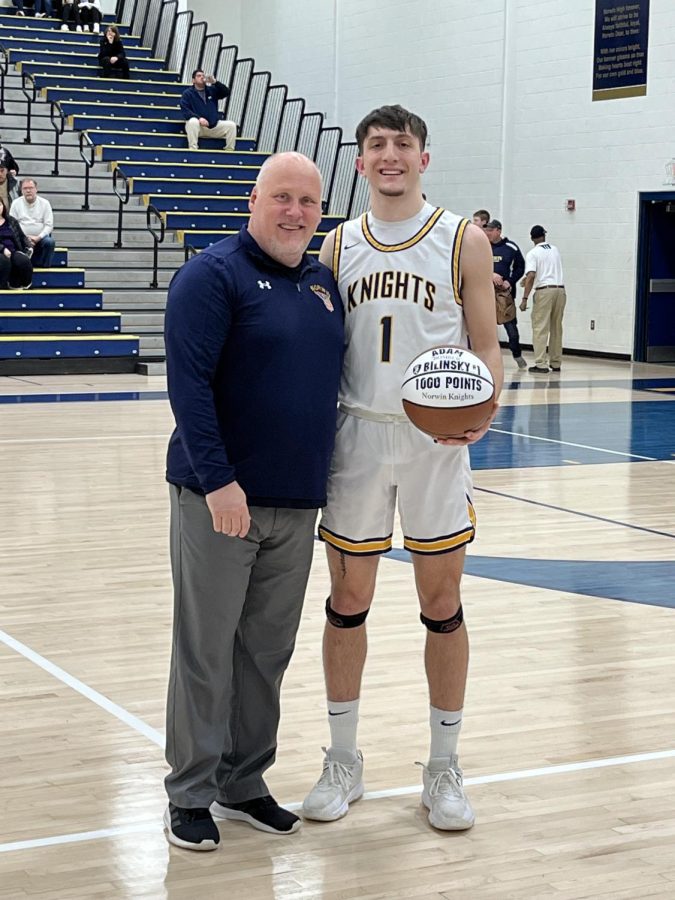 Adam Bilinsky poses with his commemorative 1000 Point Club basketball with head coach Lance Maha. 