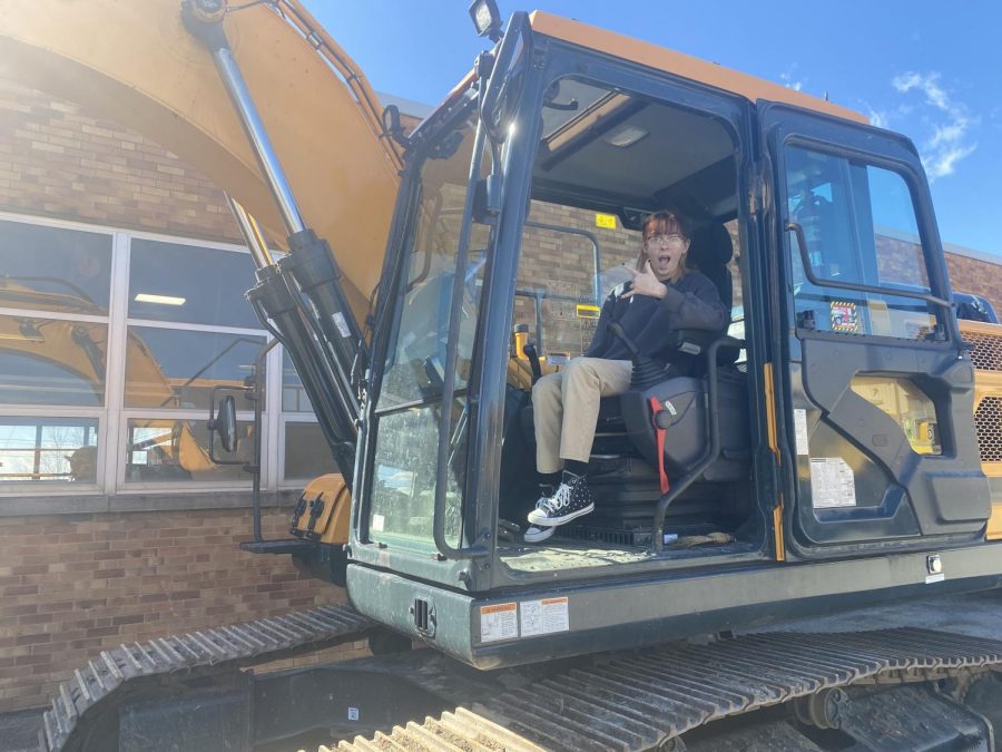 P. Tokay (11) poses for a picture inside of the excavator. 