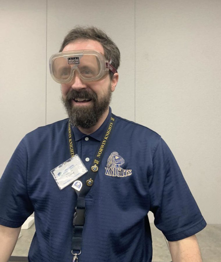 AP Statistics teacher Mr. Harskowitch poses for a picture with the daylight intoxication goggles. 