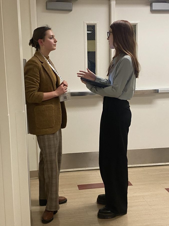Olivia Ivory (11) (right) discusses solutions with another delegate.