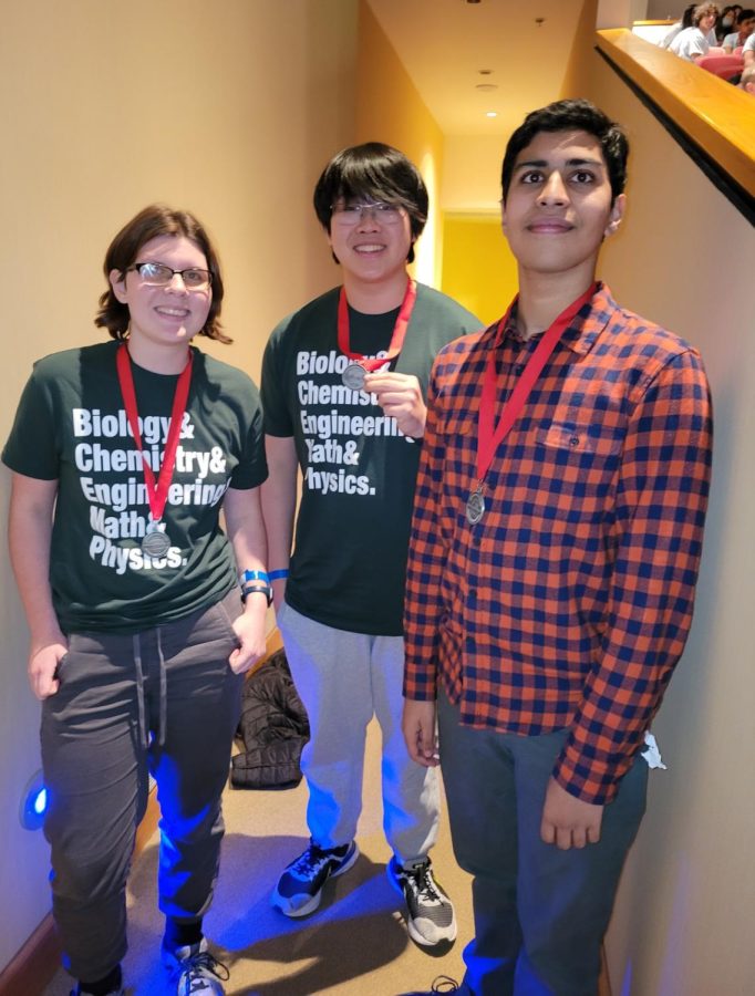 Makenzie Krance (12), Rex Wu (11), and Arnav Bedekar (11) pose for a picture with their second place medals in Experimental Design. 