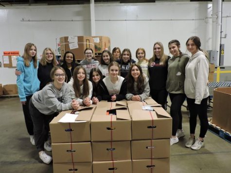 FCCLA members pose for a picture around the emergency boxes they packed.