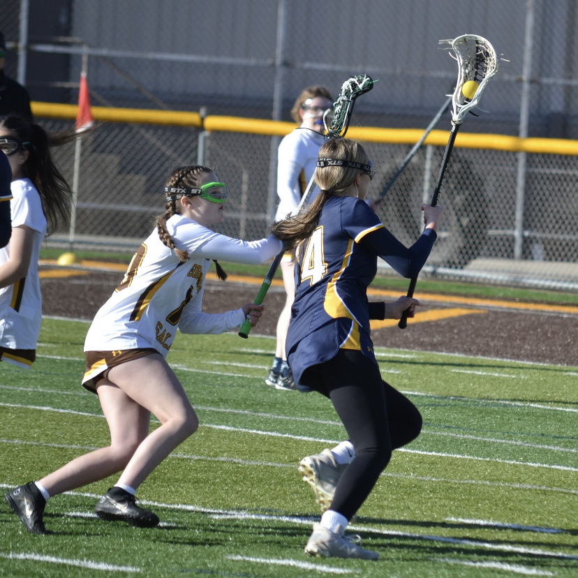 Chloe Lorenc (12) maintains control of the ball while moving it up the field. 