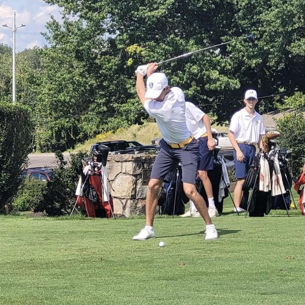 Alex Graham swinging his club on the field 2023-2024 golf season. 