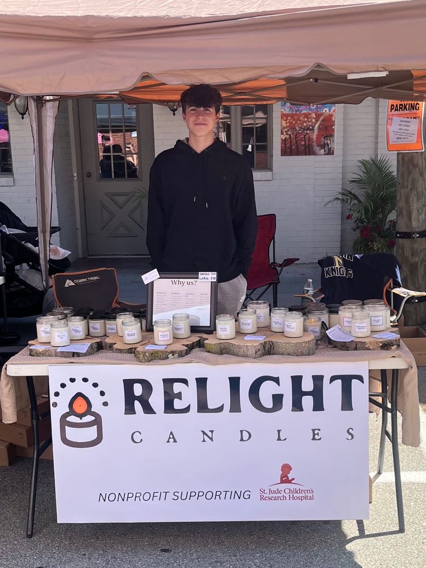 Lukas Dimitroff poses at downtown Irwin Craft Sale with his homemade candles, where profits go towards cancer treatment at St. Judes.