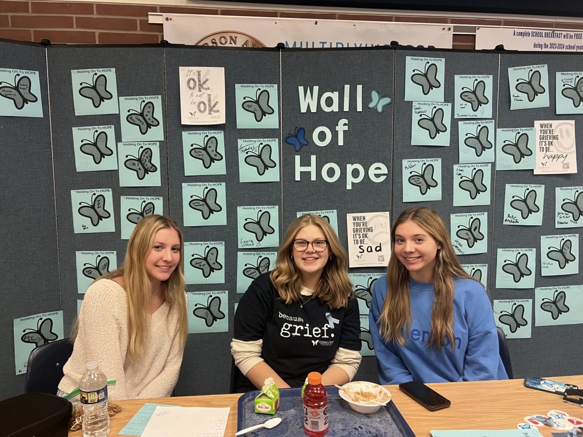 FCCLA members Allison Arendas, Adyson Clemens, and Emily Arendas sit at the Wall of Hope table during period 7 lunch, where they spread awareness and offer support to any students who need it. 
