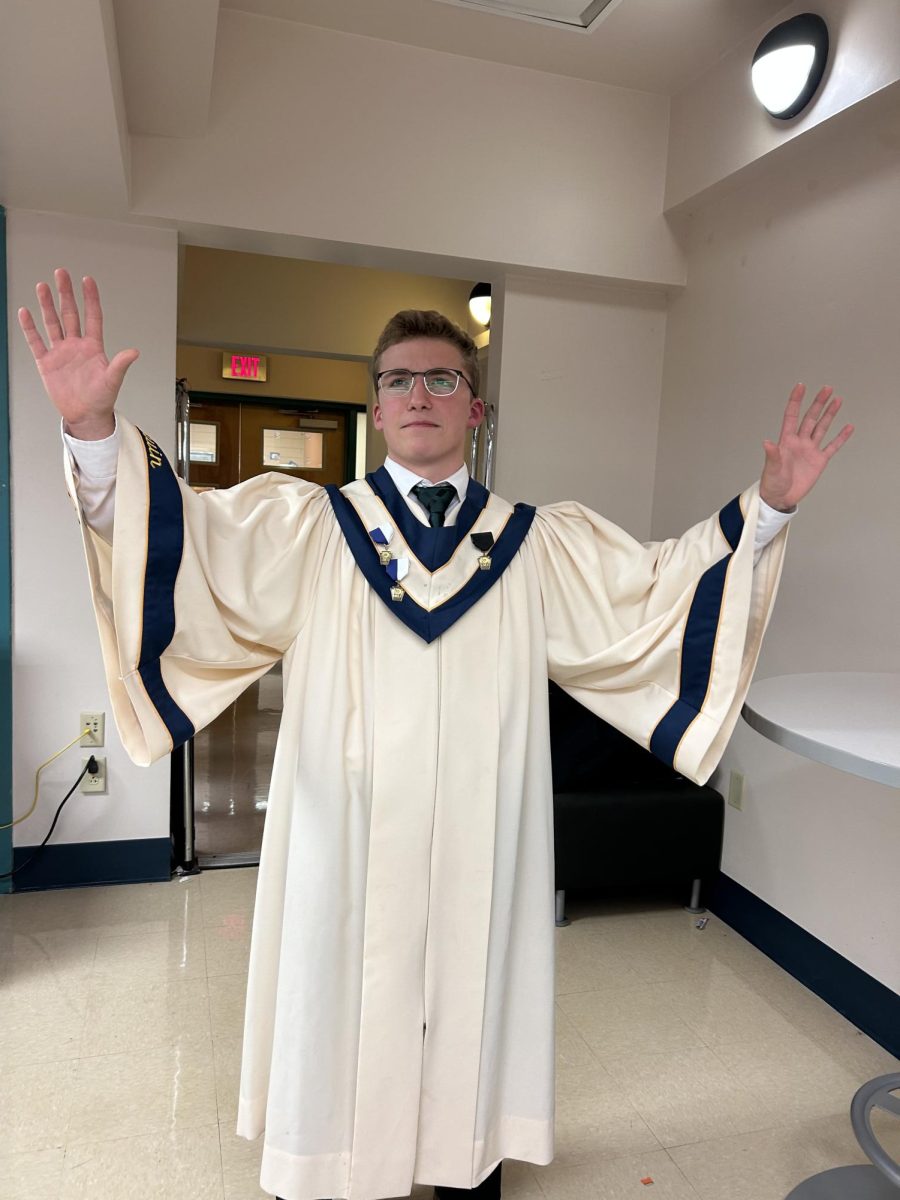 Senior Drew Brown stands in his choir robe before the WCMEA County Chorus festival. 