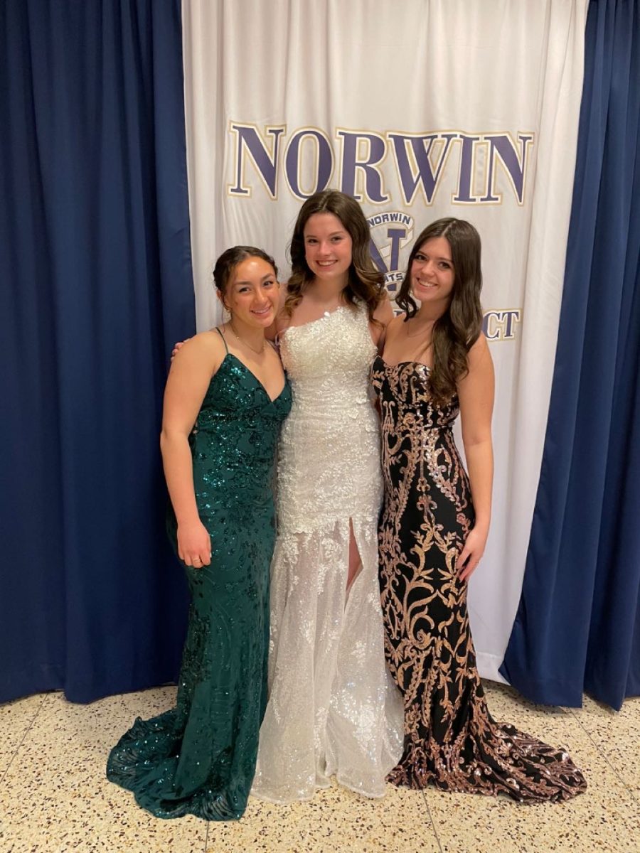 Juniors Miya Valecko, Molly Geissler, and Mackenzie Wray modeling dresses for sale at the consignment sale. 