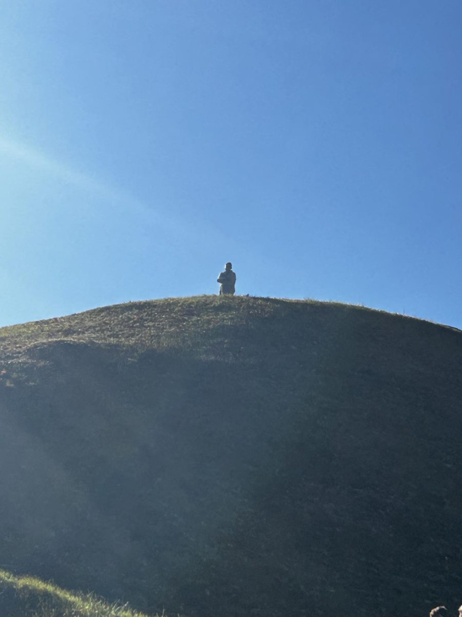 Mr. Mcelfresh, a middle school history teacher, stands at the top of the ancient Native American-built mound in West Virginia. 