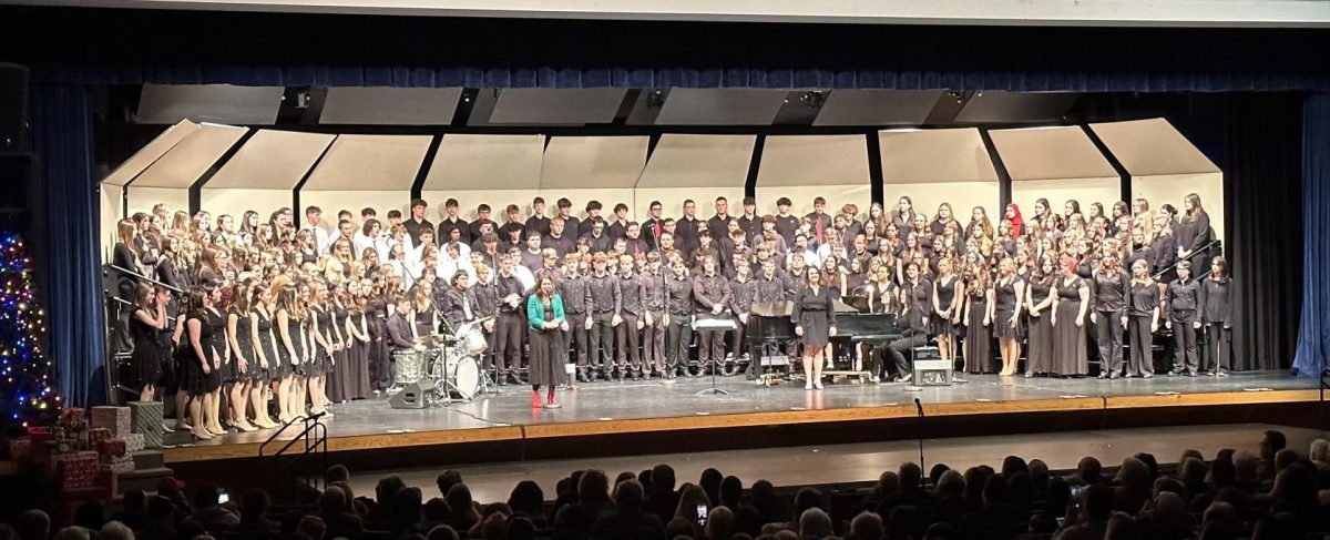 A group picture of all of the choirs on stage together to perform their final pieces. 