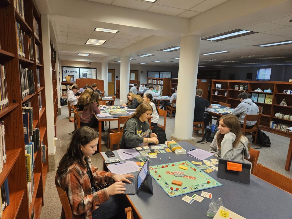 Accounting 1 students play monopoly for their midterm in the library. 