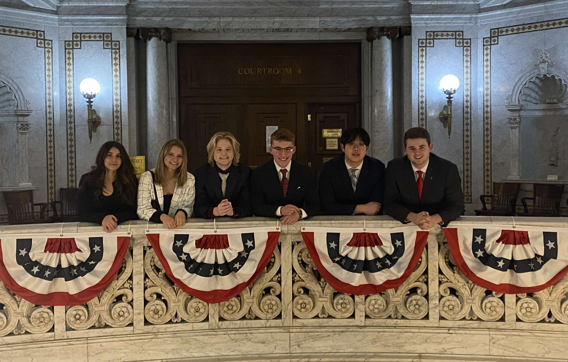Members Logan Pearce, Izzy Deflitch, Roman Ola, Drew Brown, Rex Wu, and Paxton Stauffer get together in the courthouse.