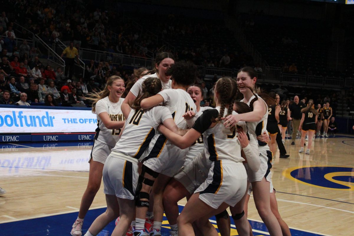 The Lady Knights topple each other in celebration as the horn sounded on Friday.