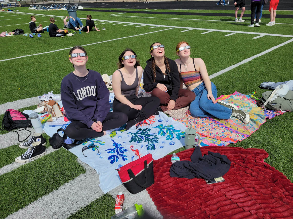 Several girls on the field trip to Cortland, Ohio, view the total eclipse with NASA glasses on. 