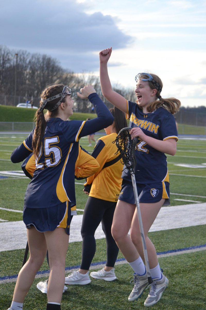 Girls LAX members celebrate together.