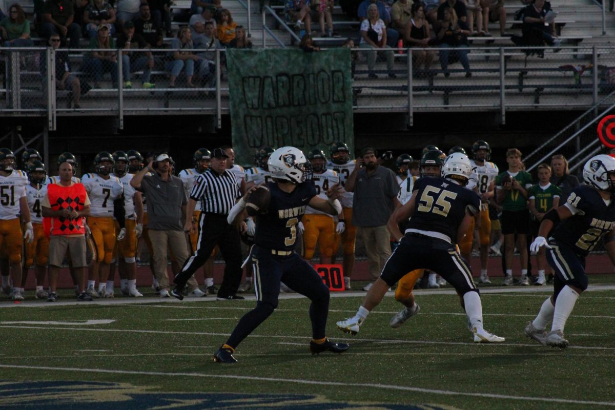 Junior quarterback Tristan Tavares loads up before he passes the ball.