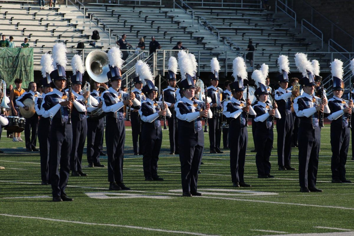 Band members take the field for their performance before the game starts.