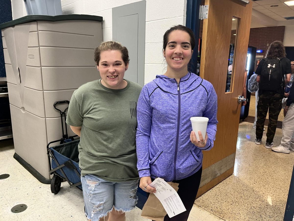 Workers Courtney Lackey (L) and Andela Gruban (R), heading out to deliver an order 