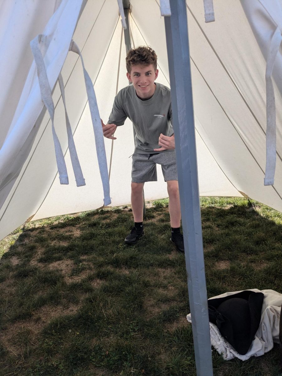 Landon Thomson (11) standing in a replica of a soldier’s tent.