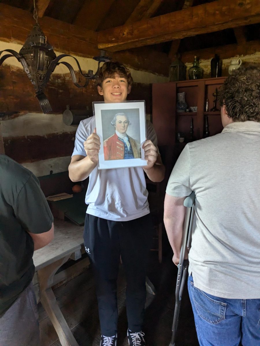 Sean Stukus (11) holding up a photo of one of the higher-ranking officers of fort Ligonier. 