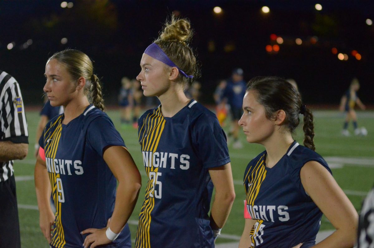 Lady Knights varsity captains Julia Bursick, Lilah North, and Lindsay Reese meet with officials and Hempfield players before the big Sectional match.