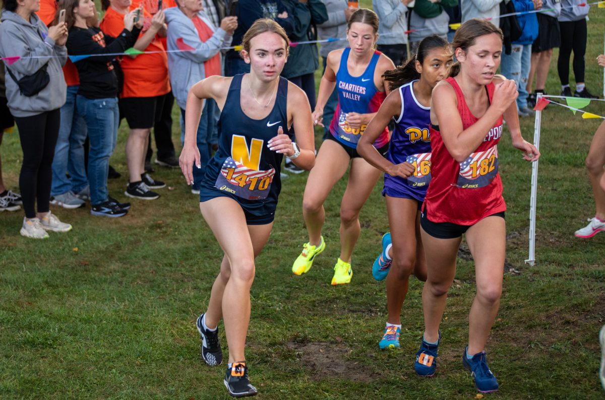 Kaelyn Lazar passes a Plum runner at the Red, White, and Blue Invitational.