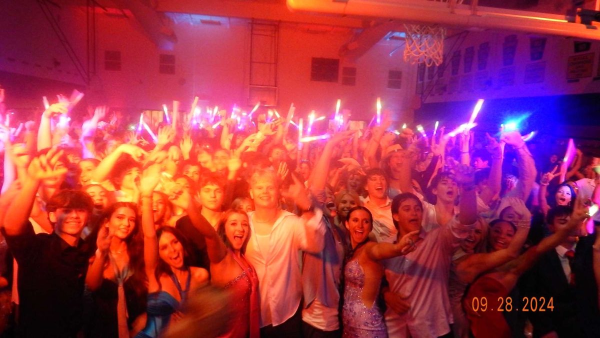 Students pose for a picture in the gymnasium for the annual Homecoming Dance "In the Big Apple."