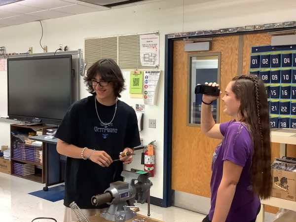 Ted Kukic (12) and Maddy Bulger (11) film a How to Solder video 