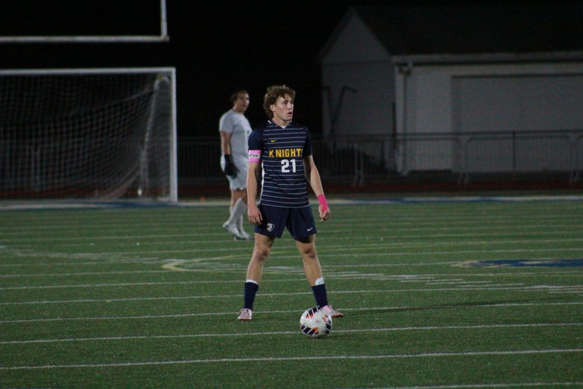 Senior Ryan Schiller surveys the field before taking the kick.