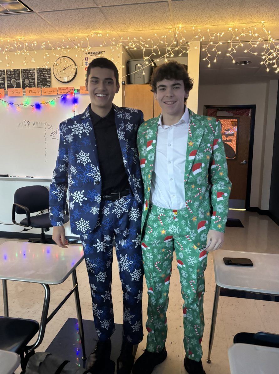 Sophomores Cal Constantino and Mason Hohman posing in their Christmas suits on game day. 