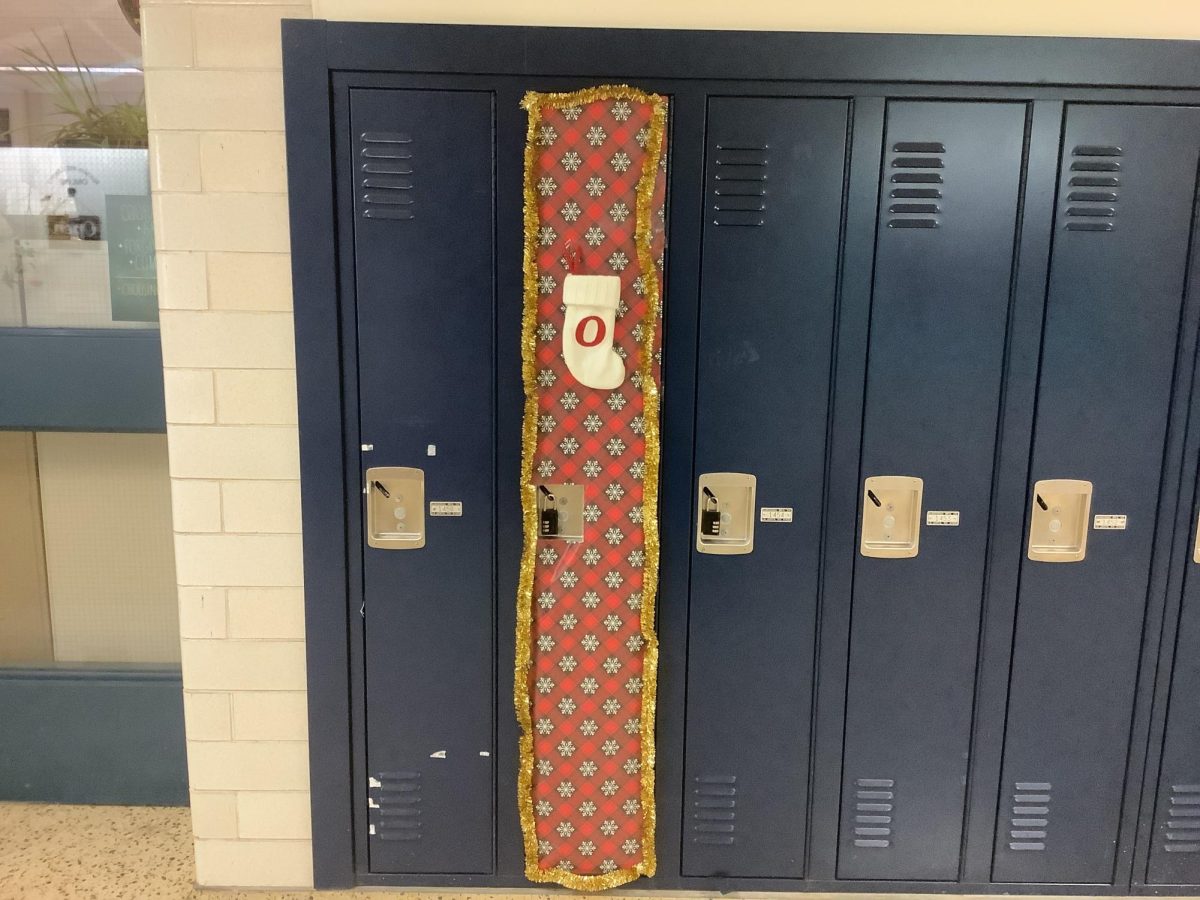 This locker was wrapped in red and white wrapping paper with a red and white stocking attached to it. 