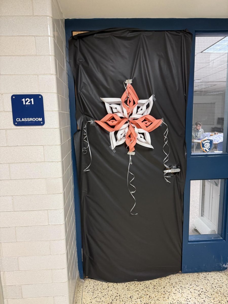 Room 121 had a design with a snowflake centered on the door which was covered in a black background. 