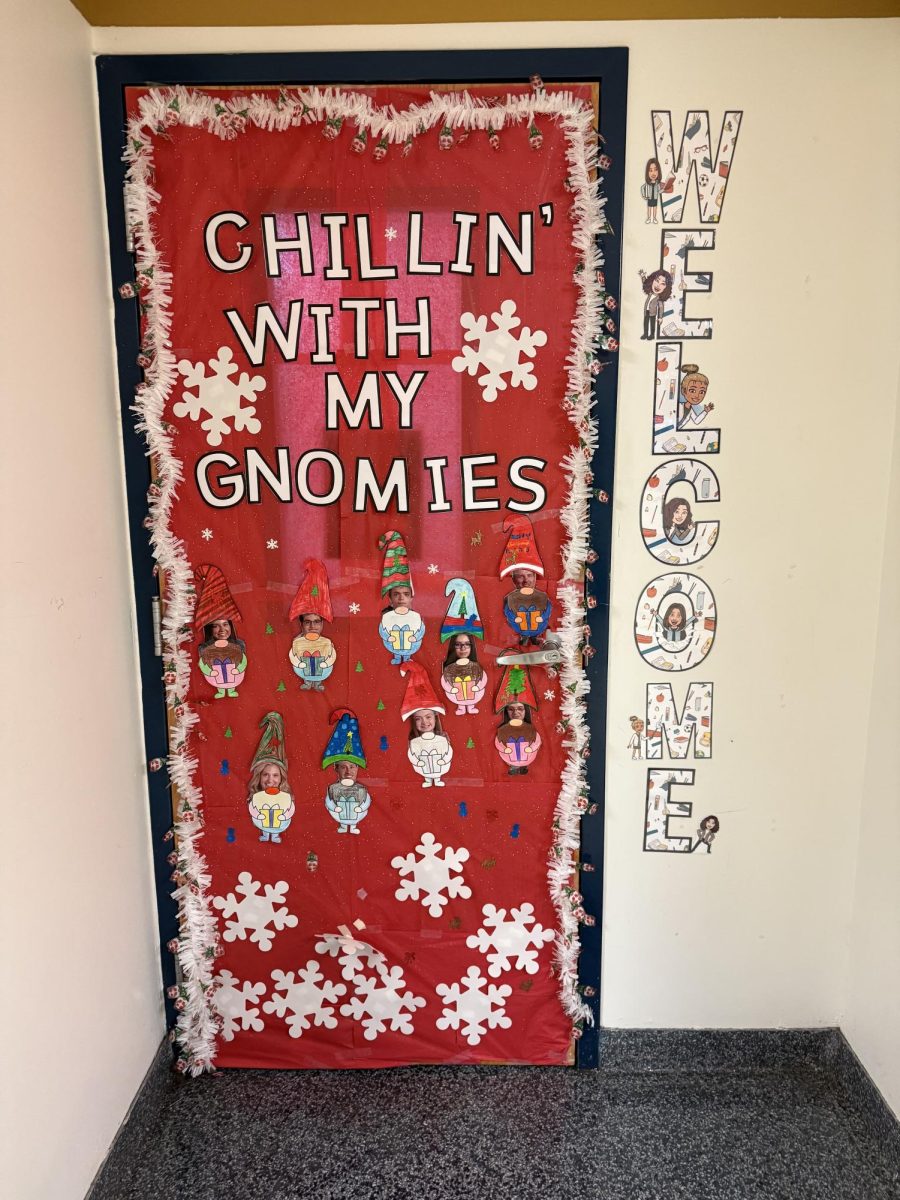 The winning door was Miss Sweeney’s room (Room 143). It was determined by the peer mentor and buddy club (PMBC) to be the best door decorated. The door has a gnome theme with a mainly red and white color scheme. 