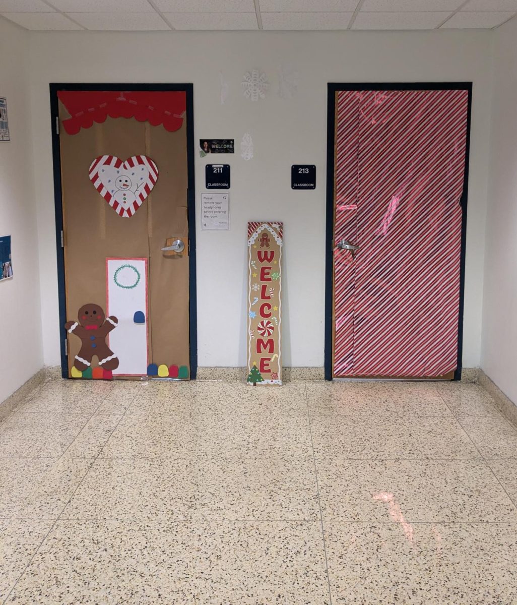 Rooms 211 and 213 has a candy cane / gingerbread theme. The one door had a gingerbread house setup with a candy cane style heart. The other door was wrapped in red-and-white pattered wrapping paper in the pattern of a candy cane.